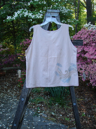 Barclay Batiste Tank Top Fern Wind Blush Size 1 displayed on a wooden rack, showcasing its straight shape, flattened neckline, and whimsical fern-themed paint.