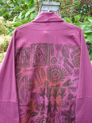 Barclay NWT Reprocessed Golden Hour Jacket Rear Folk Garden Pokeberry OSFA, featuring intricate tribal-inspired patterns on the back, hung outdoors showcasing its dense cotton texture and unique design elements.