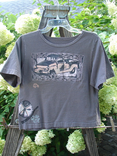 1996 KIDS Short Sleeved Tee Travel Truck Granite Size Medium: A grey shirt with a picture of a vintage farm truck painted on it.