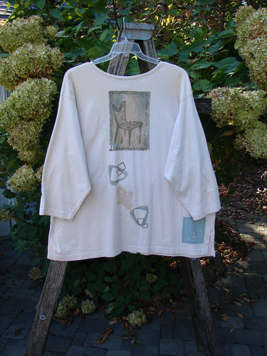 1995 Stargazer Jacket Chair Row China OSFA draped over a wooden step-ladder, showcasing block-style prints with a chair motif. Features include a painted pocket, rolled neckline, and original buttons.