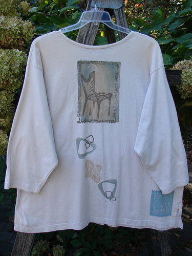 1995 Stargazer Jacket Chair Row China OSFA, a loose-fit, light-cream shirt with stylized chair and abstract motifs, hanging on a wooden ladder, showcasing vintage Blue Fish Clothing's creative freedom.