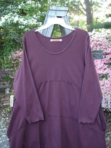 Barclay Cotton Lycra Shape Dress Unpainted Burgundy Size 1 displayed on a swinger, featuring long sleeves, a softly scooped neckline, and deep inseam side pockets.