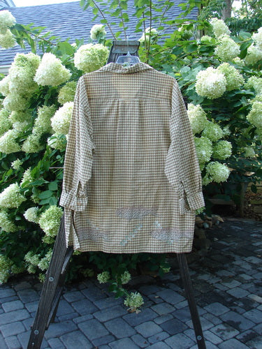 Image alt text: "1996 Tourist Top Fish Border White Pine Size 2: A long-sleeved shirt with a fish border pattern on a rack, perfect condition. Light-weight cotton percale. Full button front, cuffs and buttons, vented sides. Stand-up collar, rear upper shoulder seam. Bust 56, waist 58, hips 60, length 34 inches."