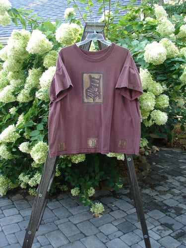 1991 Short Sleeved Tee Quiet Chair Mulberry OSFA: A t-shirt on a rack with a picture on it.