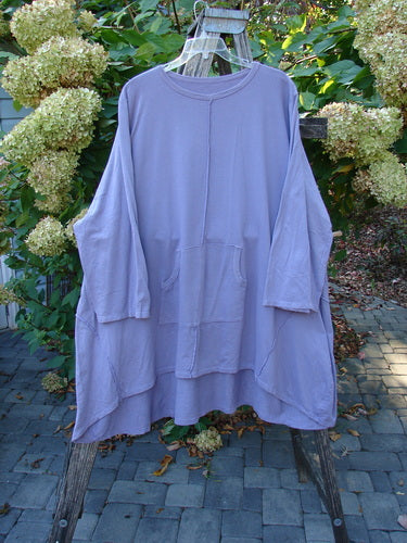 Barclay Art Studio Roo Sweatshirt Rear Rain Garden Lavender OSFA, featuring a round neckline, dropped shoulders, and kangaroo pocket, displayed on a hanger against a lush garden backdrop.