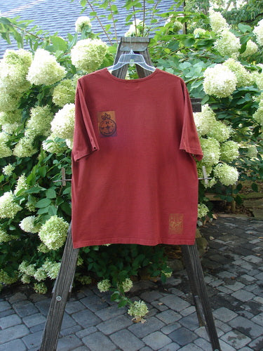 1998 Men's Artist Choice Short Sleeved Tee Earth Brick Size 2 on a ladder with logo, floral detail.