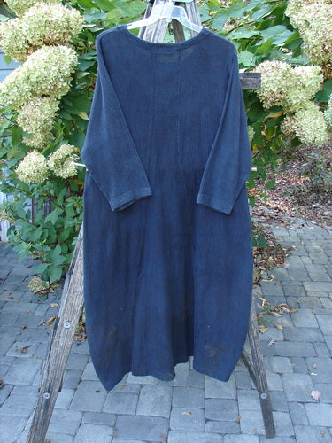 1998 Limited Edition Gauze Thostle Dress Soft Florals Raven Size 1, loose-fitting with three-quarter sleeves, hangs on a wooden ladder outdoors, emphasizing its feminine hourglass shape and softly rolled neckline.