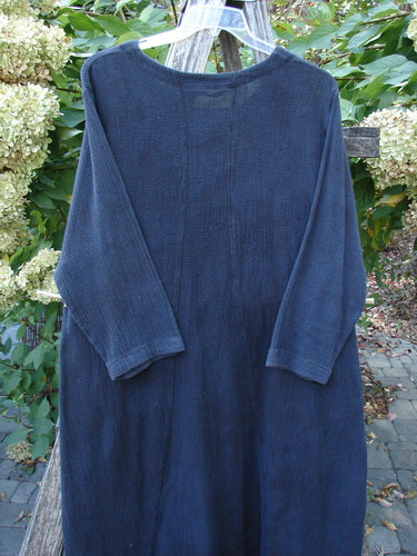 1998 Limited Edition Gauze Thostle Dress Soft Florals Raven Size 1, long-sleeved, textured navy dress with elastic-topped pockets, softly rolled neckline, hanging outdoors, embodying BlueFishFinder's vintage, expressive style.