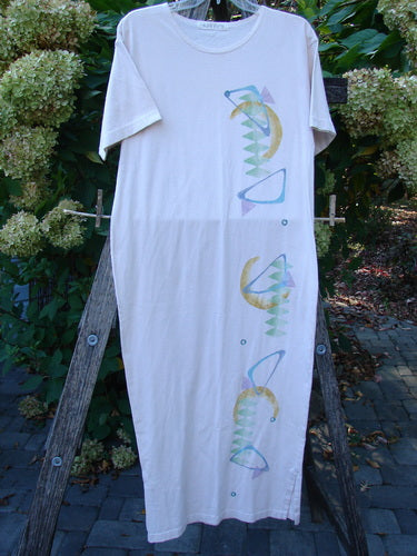 1996 Long Tea Dress Half Moon Birch Bark Size 0 hanging on a wooden ladder, featuring a rounded neckline, seamless front, and abstract pastel pattern. The dress embodies the vintage Blue Fish Clothing style.