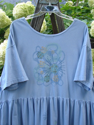 Image alt text: Barclay Collector's Tunic Dress, faded sky, size 2, with starburst paint and dandelion flowers on flouncy skirt.