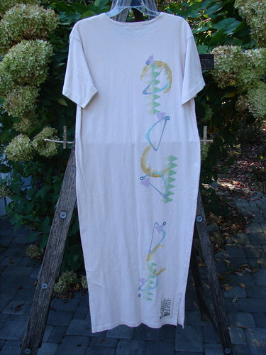 1996 Long Tea Dress Half Moon Birch Bark Size 0, featuring a vertical pattern of pastel seahorse-like shapes on organic cotton. The dress displays wide sleeves, a rounded neckline, and a pegged vented hemline.