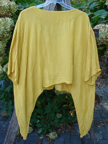 Barclay Rib Silk Dip Side Button Jacket in Golden Sunshine, shown on a hanger with a drapey silhouette, wide sleeves, and a varying hemline, exemplifying BlueFishFinder's creative vintage style.
