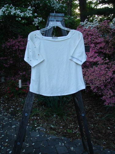 2001 Boatneck Top Dot to Dot Fizz Size 1 displayed on a wooden stand, showcasing a shallow boatneck, painted short sleeves, and playful dot pattern.