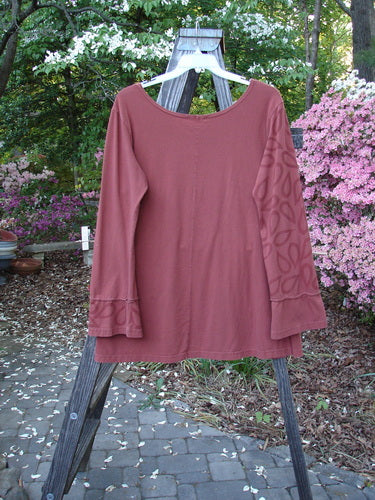 Barclay Cotton Lycra Bell Sleeved Vented Top Paisley Rust Size 2 on a clothes rack, featuring long belled sleeves with exterior stitchery and dual vented sides in an hourglass to A-line shape.