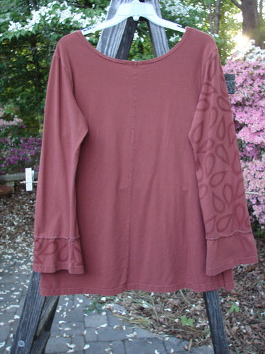 Barclay Cotton Lycra Bell Sleeved Vented Top Paisley Rust Size 2 on a wooden rack, showcasing its wide neckline, belled sleeves with painted panels, and dual vented sides.