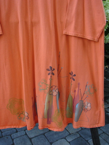A close-up of a Barclay Hi Low Tunic Top in tangerine, made from organic cotton. Features include a rounded soft neckline, varying hemline, and longer three-quarter length sleeves. Size 2.