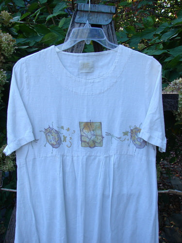 1999 Textured Linen Water Dress Garden Friends White Size 0, featuring an empire waistline and botanical-themed panels across the chest, hangs outdoors showcasing its unique basket weave texture and softly rounded neckline.