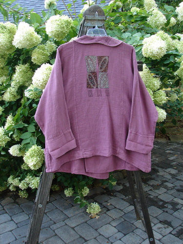 Barclay Hemp Vienna Toggle Collar Jacket Step Stone Peony Size 2: A substantial purple shirt with a patchwork design, featuring a folded layered neckline and oversized wooden toggle.