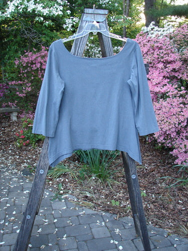 Barclay Cotton Lycra Square Neck Pinch Pullover Unpainted Grey Sky Size 1 displayed on a wooden rack, showcasing its unique neckline and vertical pinch accents.