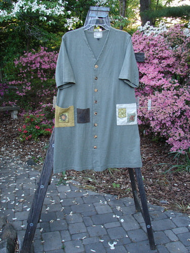 2000 Cotton Hemp 3 Block Cardigan Sun Pocket Loden Size 1 displayed on a rack, showcasing its straight elongating shape, V neckline, and three colorful painted front pockets with original Blue Fish buttons.