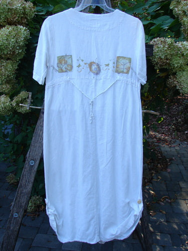 1999 Textured Linen Water Dress Garden Friends White Size 0: Knee-length dress with faded floral panels on the back, drawcord accents, and a gathered hem, showcasing vintage elegance and creative freedom.