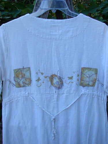 1999 Textured Linen Water Dress Garden Friends White Size 0, featuring a scoop neckline, empire waist, and botanical prints of leaves, mushrooms, and vines, elegantly hanging outdoors, embodying vintage Blue Fish Clothing style.