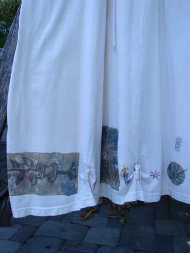 1994 Loop Dress Magic Garden Tea Dye Smaller OSFA features a white, ankle-length skirt with mechanical and abstract prints, circular motifs, and insect graphics. Three fabric ties enhance its unique, vintage style.