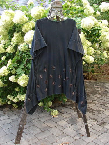 Image alt text: Barclay Double Pocket Bounce Tunic Dress - Black shirt with skull design on a swinger, featuring wrap-around side curvy sectional exterior seams, oversized front drop bushel pockets, and a dramatic upward scooped hemline.