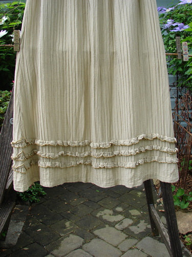 Barclay Rib Silk Triple Ruffle A Line Skirt in Sand, Size 0, elegantly displayed on a clothesline. Features a fluttery triple ruffle design, silken texture, and full elastic waistline. Vintage Blue Fish Clothing from BlueFishFinder.com.