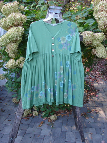 Barclay Tree Top Cardigan Dress Floral Blossom Spearmint Size 3 features a loose-fitting, short-sleeved design with a button-front bodice, gathered skirt, and vintage buttons, set on a wooden form outdoors.