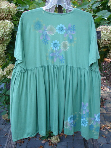 Barclay Tree Top Cardigan Dress Floral Blossom Spearmint Size 3, featuring pastel floral prints, a V-neckline, vintage buttons, and a gathered lower hem, hanging against a natural backdrop.