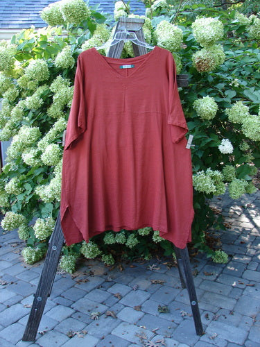 Barclay Linen Viscose Vented Urchin Dress Unpainted Brick Stripe Size 2: A red shirt on a swinger with a red cloth under a tablecloth.