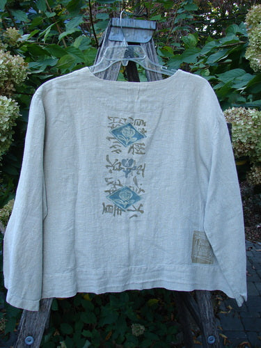 1999 Summercloth Hemp Crop Jacket Nature Cement Size 1 displayed on a stepladder outdoors, features two stylized fish on the back and a patch, reflecting Bluefishfinder.com's vintage, artistic ethos.