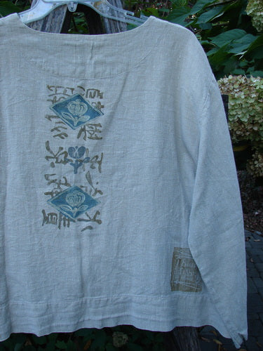 1999 Summercloth Hemp Crop Jacket Nature Cement Size 1 features a loose-cut design with a vertical block-print motif in muted blues and tans, showcasing two diamond floral patterns and Asian-style characters.