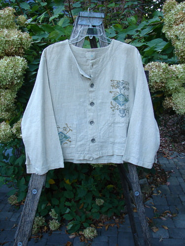 1999 Summercloth Hemp Crop Jacket Nature Cement Size 1 displayed on a wooden ladder, featuring dark buttons, a patch pocket, decorative motifs, and the signature Blue Fish stamp, embodying vintage Blue Fish Clothing's creative freedom.