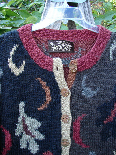 Tara Handknits Star Button Pocket Cardigan Leaf & Moon Brights OSFA, a hand-knit sweater featuring intricate leaf and moon motifs, chunky burgundy and cream neckline, star buttons, and dual pockets, exemplifying artisanal craftsmanship.