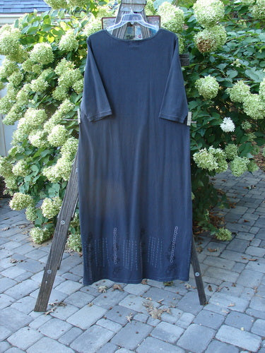 2001 NWT Tide Dress Celtic Knot Licorice Size 2: A blue dress on a clothes rack, featuring a slightly flared lower, three-quarter length sleeves, and signature Junk Drawer and Celtic Knot theme paint. Perfect for layering or as a simple dress.