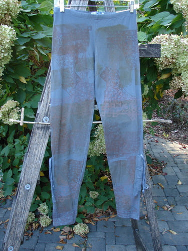 Barclay Cotton Lycra Side Gather Legging Lattice Moss Size 0, featuring a map-like print, hangs from a wooden stepladder in a garden setting, showcasing its unique design and fit.