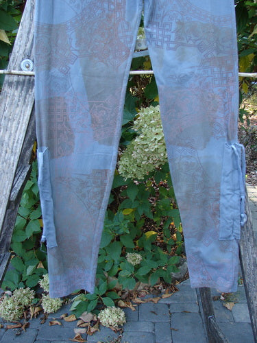 Barclay Cotton Lycra Side Gather Legging Lattice Moss Size 0 is displayed on a wooden ladder, showcasing its geometric print and cargo-style pockets, with a soft, tapered fit and elastic waistband.