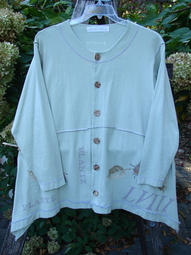 1998 Botanicals Orchard Jacket Plante Grasshopper Altered Size 1: Pale-green, long-sleeved cardigan with wooden buttons, uneven hem, leaf graphics, and faint lettering. Showcasing unique Blue Fish Clothing's creative expression.