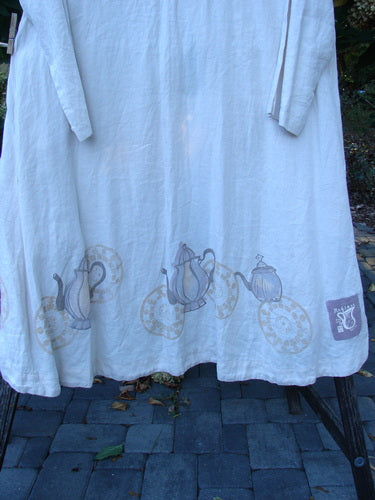 1999 NWT Cream and Sugar Coat Tea Time Teadye OSFA, a loose-fit, long-sleeved garment with tea-time motif along hem, featuring deep side pockets, V-neckline, and single oversized shell button closure.