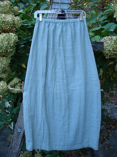 2000 Cross Dye Linen Contour Skirt Unpainted Meadow Size 0, displayed outdoors on a hanger, features a full elastic waistband and paneled sides for a contoured fit, showcasing Bluefishfinder.com's vintage style.