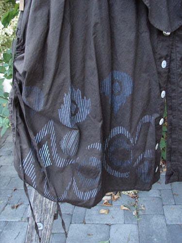 Barclay Batiste Split Button Pant Skirt Celtic Mocha Size 0 hanging outdoors, showcasing a faded blue concentric circle pattern along the hem, buttons, and draw-string detailing.