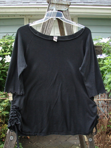 Barclay Boatneck Draw Side A Line Top Unpainted Black Size 1 on a wooden stand, showcasing its boat neckline, three-quarter sleeves, drawcord sides, and A-line shape.