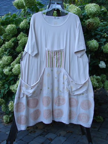 Barclay Farmer Jen Tunic Dress Fallen Flower Pale Pink Size 2: A white dress with pink and green circles, featuring a rear elastic tab, oversized bushel front drop pockets, and a lower bell shape.