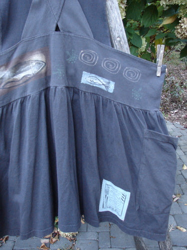 1995 Overall Jumper Fish Space Briquette OSFA hanging outdoors, showcasing a gathered skirt with block-print motifs on the waistband, roomy side pocket, and crisscross back straps, embodying Bluefishfinder's vintage charm and creativity.