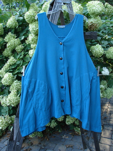 Barclay Column Vest Unpainted Royal Teal Size 2: Swingy shape, dark buttons, varying hemline. Organic cotton vest on clothesline.