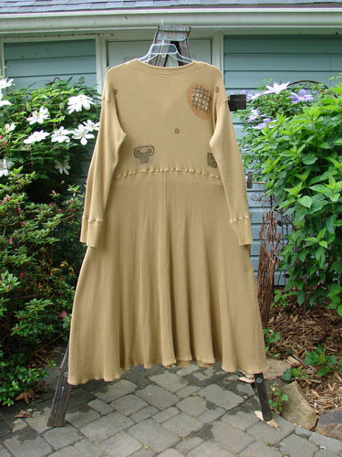 Vintage 1995 Thermal Soliloquy Dress in Burnished Gold, Size 2, by BlueFishFinder. Architectural design with ribbed accents, drop waistline, and sweeping hemline. Perfect for creative expression.