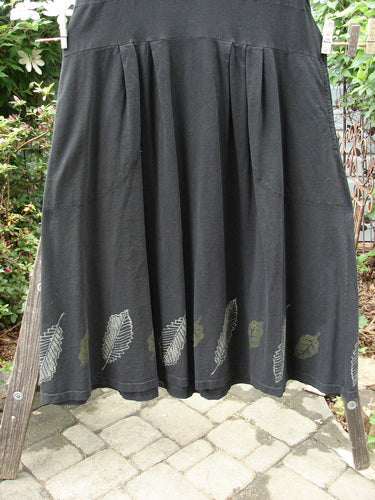 Vintage 2000 LuLu's black skirt with leaf design on clothesline. Organic cotton, yoked waistline, drop pockets, button closure, pleated darts, swingy lower, and unique loops. Bust 44, waist 44, hips 58, hem 100, length 51 inches.
