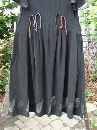 Vintage 2000 LuLu's black skirt with pattern, string, and stone detail. Organic cotton, yoked waistline, drop pockets, button closure, swingy lower, pleated darts, leaf paint theme, and rippie loops. From BlueFishFinder.